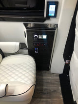 Sleek RV interior with white quilted seating, digital control panels, and cupholders. Experience comfort in this RV rental.