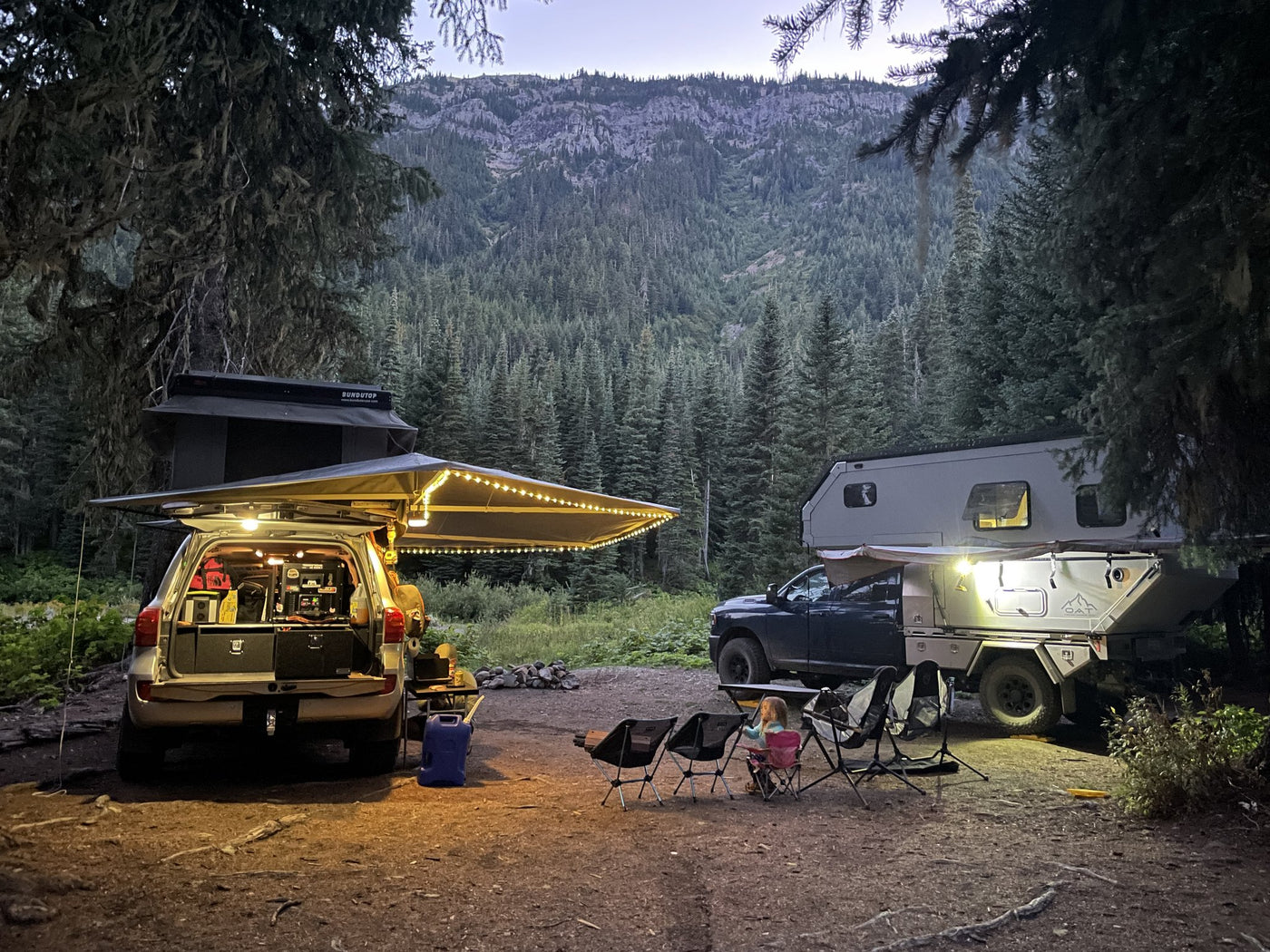 Rooftop tent and awning setup at a campsite at dusk — photo 8