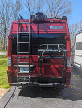 Rear of a red Winnebago Travato camper van, equipped for adventure with a ladder & bike rack. Ideal for an RV rental.
