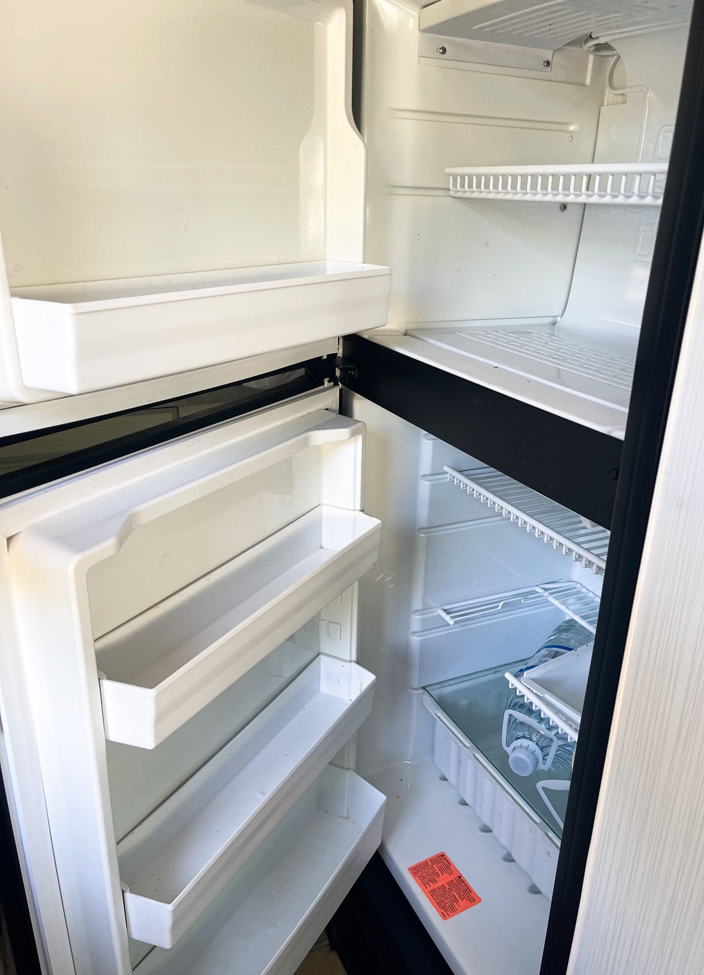  and open rear doors to scenery.|RV rental: Modern van kitchen with induction cooktop — photo 17