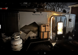 Night view of a gray Boreas XT overland camper with propane, water jug, & lighted door, great for RV rental.