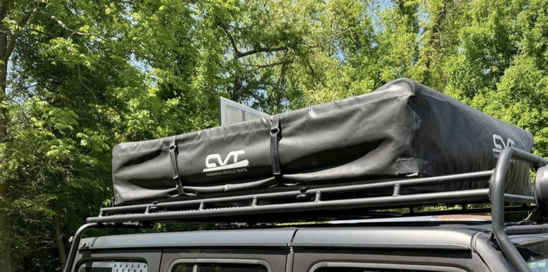 Tent closed in its black CVT travel cover, mounted on the vehicle roof rack — photo 4
