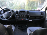 RV rental cockpit view: Ram dashboard with steering wheel, gear shift, radio, climate, seats. Ready to go!