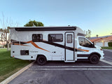 RV rental: A white & gray Coachmen Transit 250HD AWD motorhome parked outdoors, ready for travel.