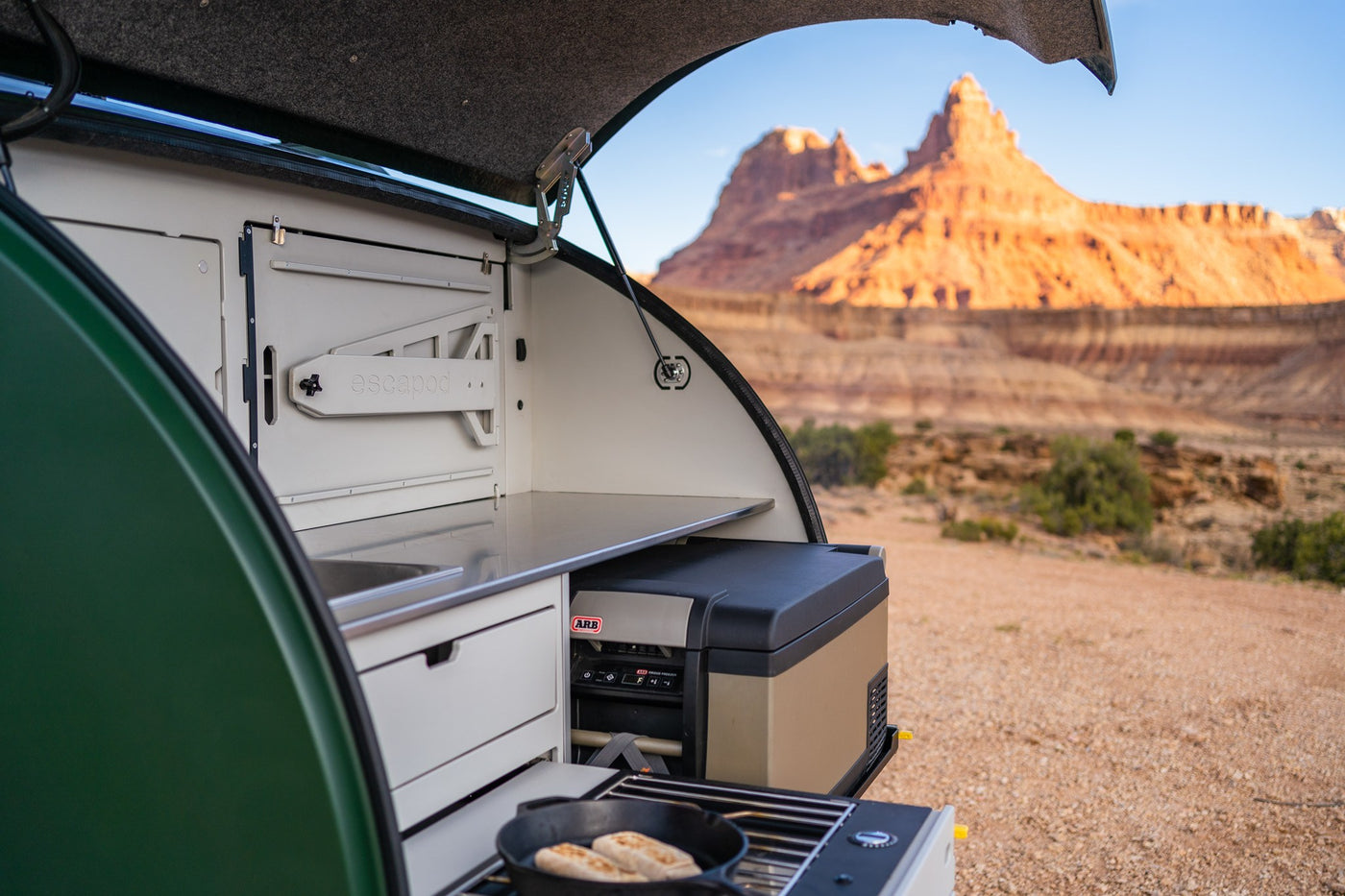  and cup holder in an organized interior.|Explore the ultimate RV rental with this pull-out camping kitchen: stove — photo 2