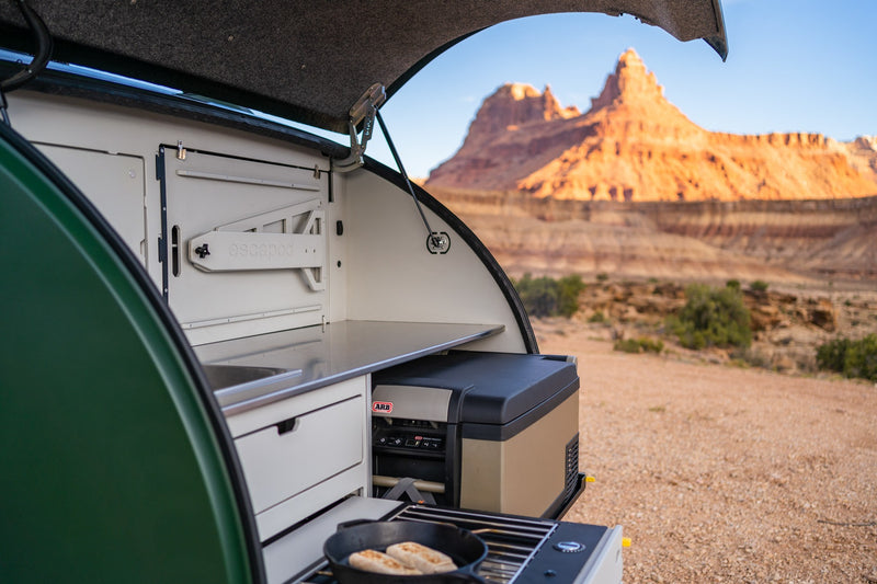  and cup holder in an organized interior.|Explore the ultimate RV rental with this pull-out camping kitchen: stove — photo 2