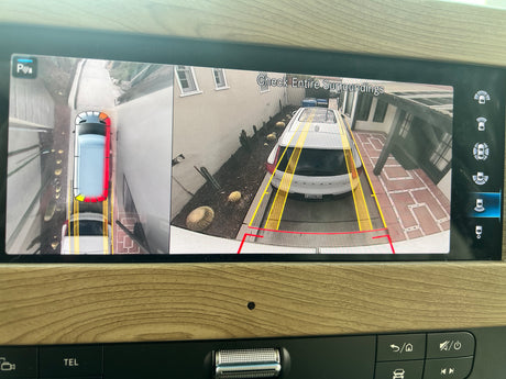 RV rental's digital display shows 360-degree views for parking. Top-down and rear cameras with guides assist navigating tight spaces.