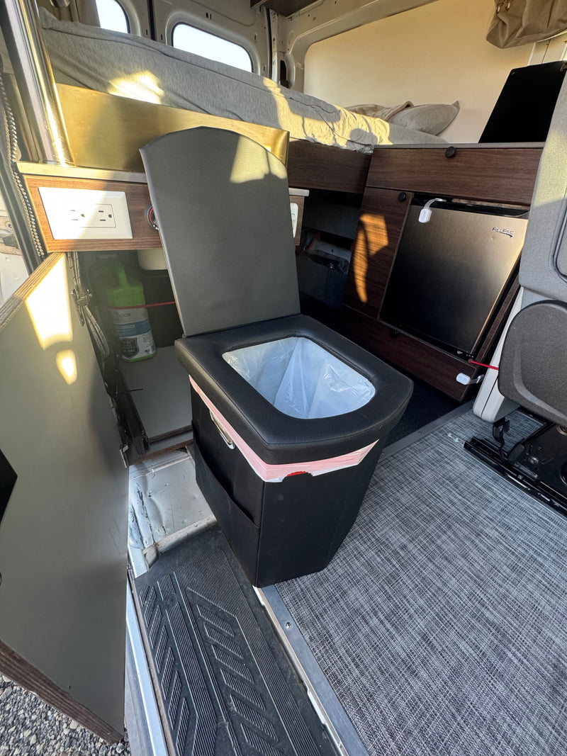  and passenger seats are visible from the open side door.|RV rental: Modern camper van interior with a golden sink — photo 18