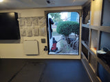 RV rental interior: organized storage, durable flooring, and an open door. This camper setup is ready for adventure.