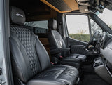Premium rv rental cab interior featuring plush black quilted leather seats, "Legends" headrests, and a sophisticated design.