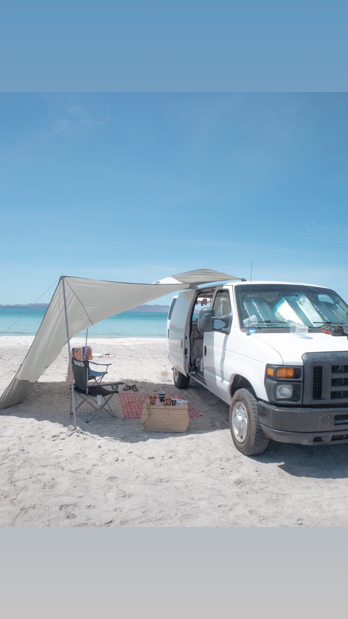  plus smart storage for van travels.|Cozy rv rental bed with scenic ocean view and a seagull outside. Perfect for coastal adventures!|Bohemian RV rental interior featuring a daybed — photo 2