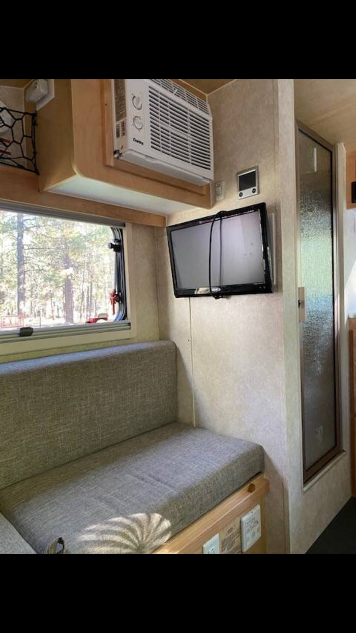  wood-paneled kitchenette with fridge