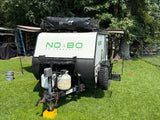  a white NOBO travel trailer with a Rhino-Rack awning
