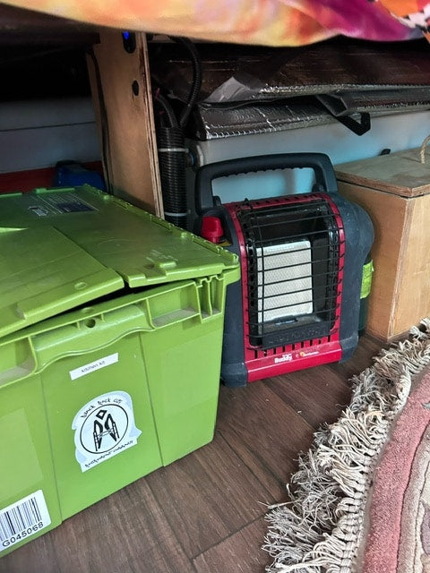  parked roadside. Features a roof rack and side awning.|Straight-on view inside an RV rental van — photo 2