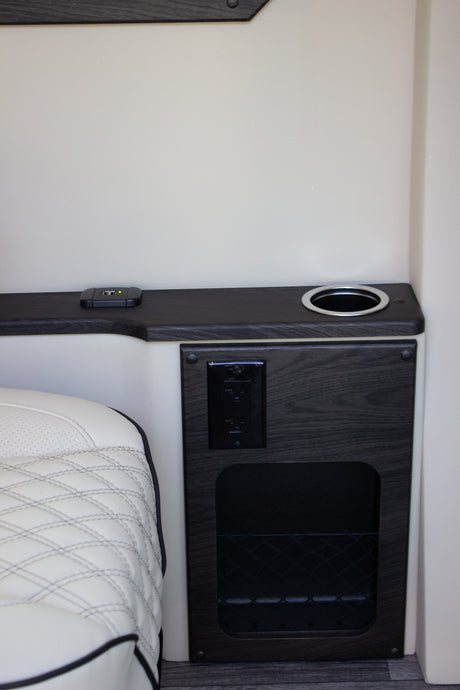 RV rental convenience: This modern interior features a quilted seat, USB/AC charging, cupholder, and mesh storage.