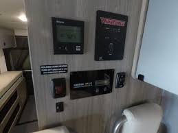  and a dog.|This modern RV rental interior features a bright living space with a kitchen — photo 5