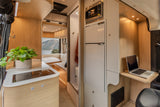 This modern RV rental offers a compact kitchen, cozy dining area with scenic views, bathroom, and a functional mobile office.
