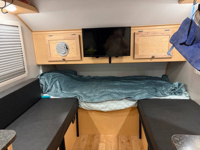  and a magnetic screen door for bug-free travel.|This RV rental features a modern interior with a compact kitchen including microwave — photo 6