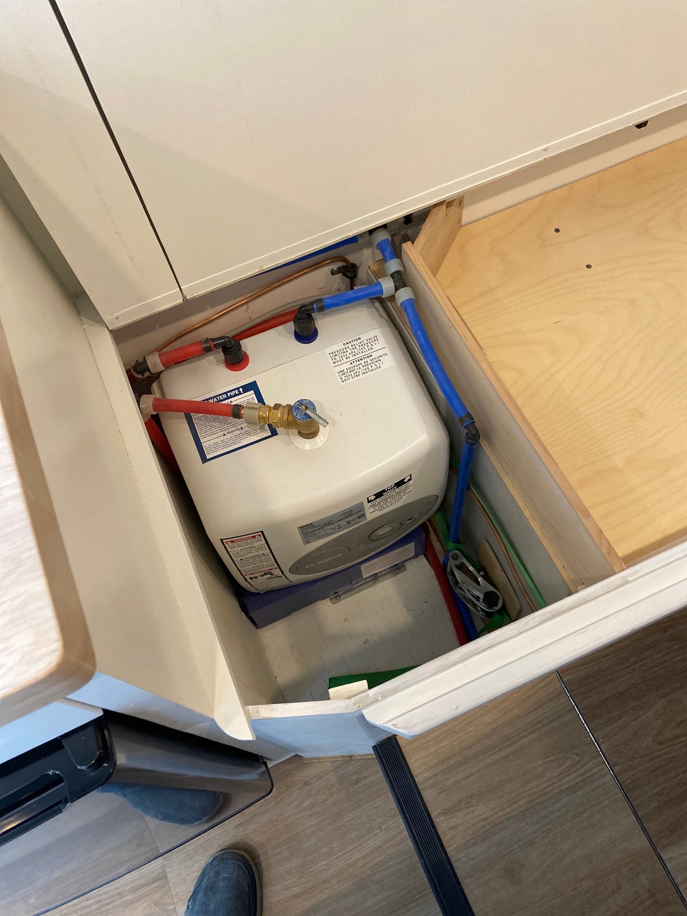 RV rental's under-counter Bosch hot water heater and PEX plumbing, ensuring hot water on the go for guests. — photo 7