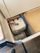 RV rental's under-counter Bosch hot water heater and PEX plumbing, ensuring hot water on the go for guests.