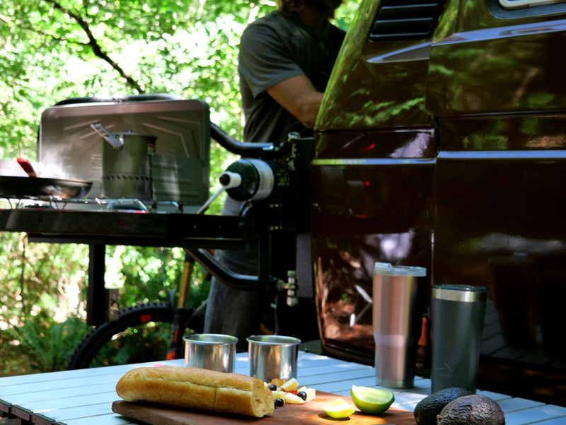  and a compact living space.|Stunning lake views from an RV rental! A brown camper van and person admire the deep blue lake framed by mountains.|Brown pop-top VW camper van in a sun-dappled forest — photo 5