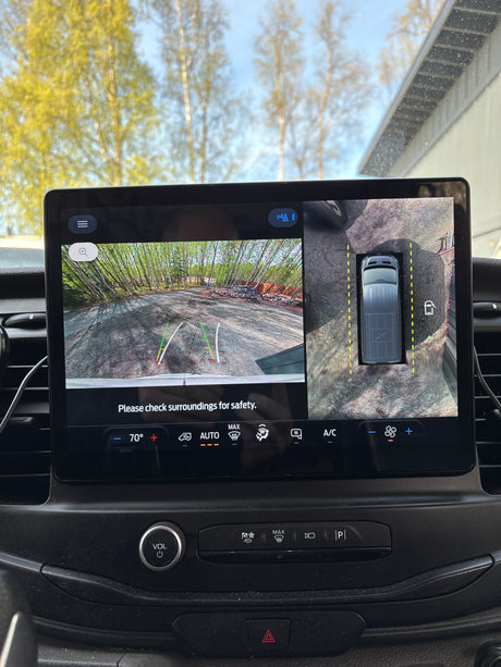 Inside an RV rental, a large touchscreen infotainment display shows 360 camera views for parking assist, with climate controls visible.