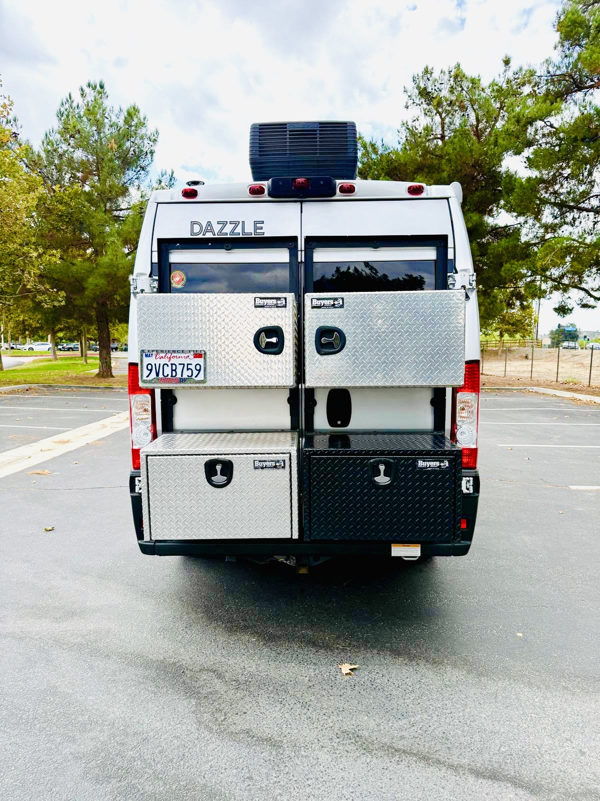  revealing a peek at the cozy interior.|Light gray Dazzle RV rental with its pop-top open — photo 3