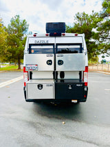Rear view of a white Dazzle rv rental, equipped with four diamond plate Buyers Products toolboxes for ample storage.