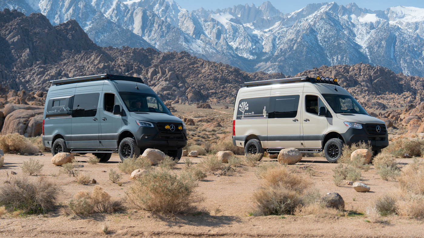 Two custom Sprinter rv rental vans (grey & beige) in a rocky desert, backed by snowy mountains. Perfect for adventure. — photo 9