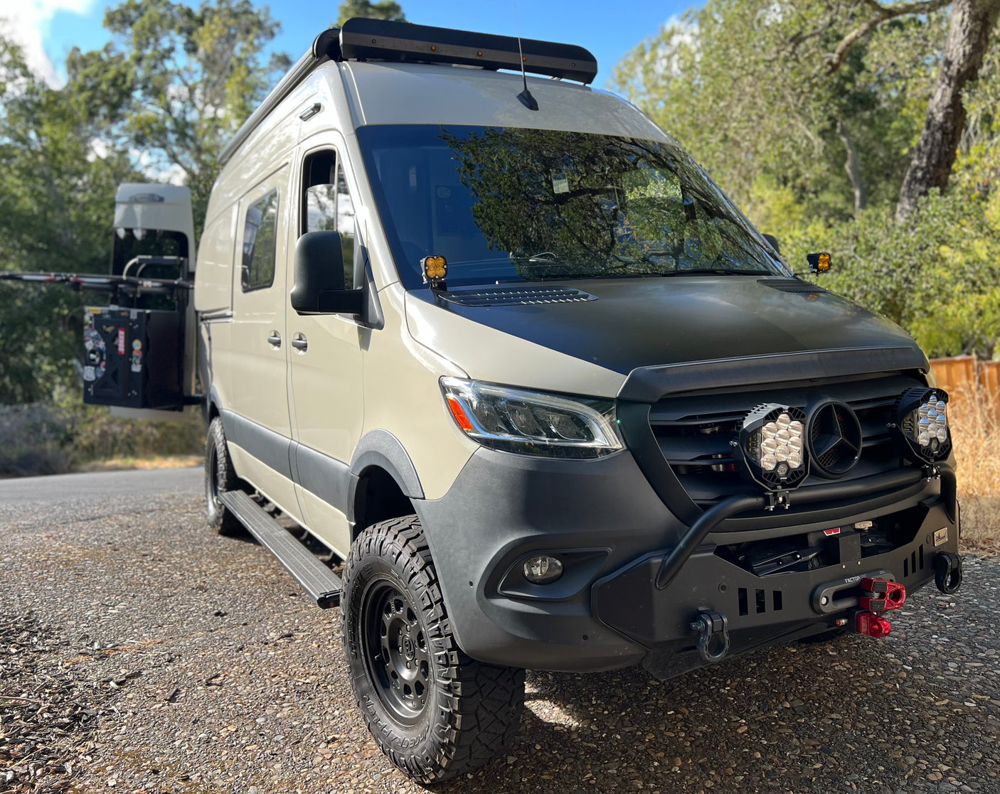 A rugged, customized Mercedes-Benz Sprinter van, ready for your next rv rental adventure. Equipped with off-road lights and gear.