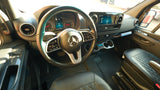 Mercedes-Benz Sprinter RV rental: Driver's cockpit with modern dashboard, steering wheel, and infotainment screen.