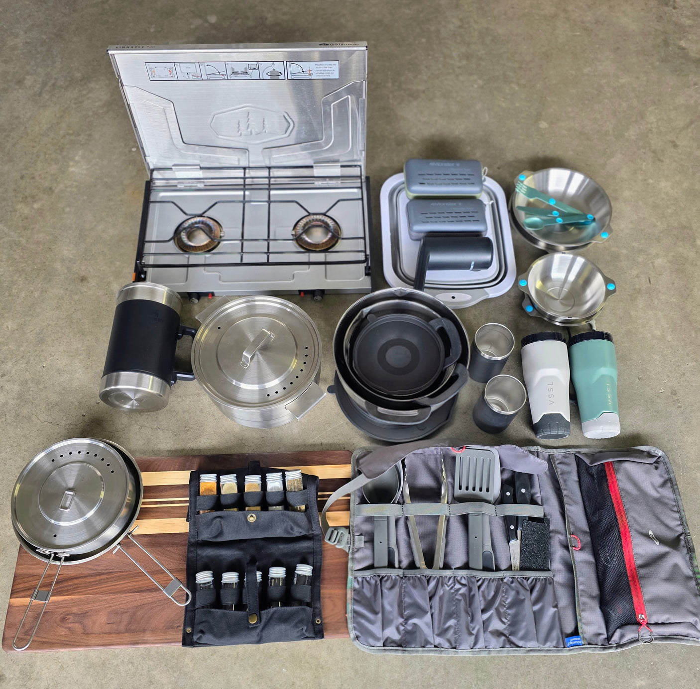 Equip your rv rental for outdoor cooking! This setup includes a camp stove, pots, pans, dishes, spices, and utensils.
