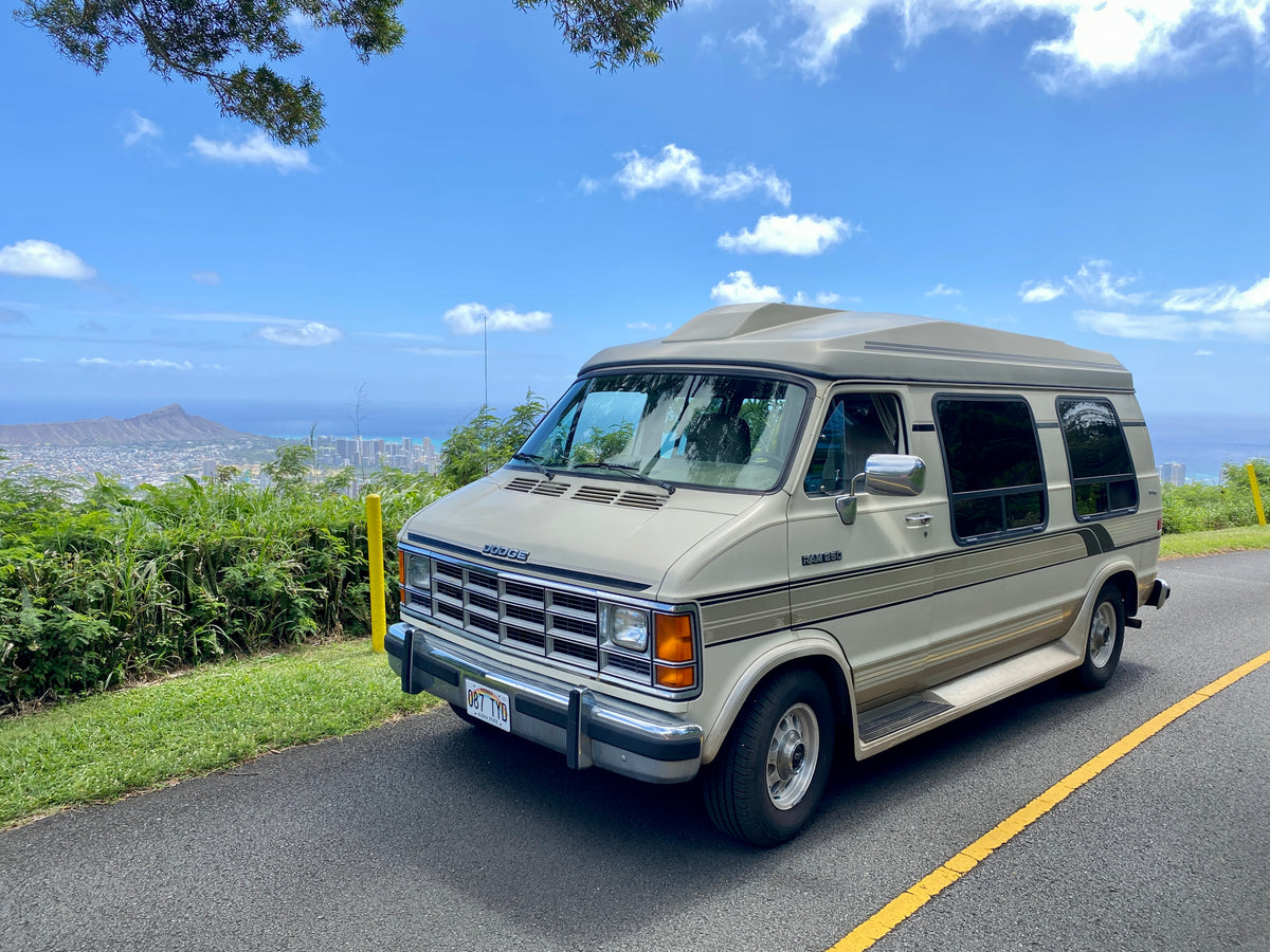 A beige Dodge conversion van, likely an RV rental, parked on a scenic Hawaii road overlooking Honolulu & Diamond Head. — photo 2