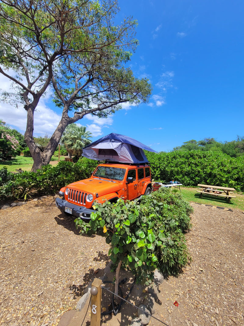 Orange Jeep with rooftop tent at sunny Hawaiian campsite. Ideal RV rental for exploring, perfect for outdoor travel. — photo 14