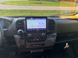 RV rental interior: modern dashboard with large navigation screen, gear shift, and climate controls. Ready for travel.