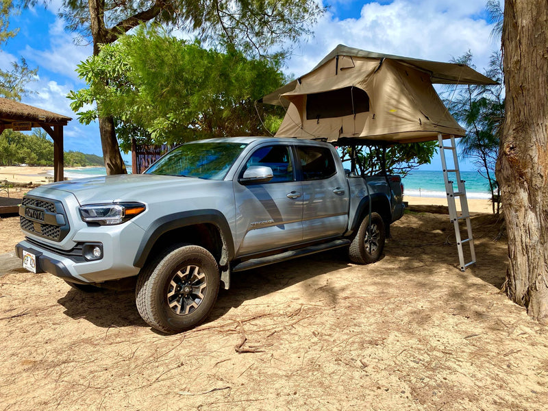 Grey Tacoma with rooftop tent. Ideal RV rental setup for beach camping adventure! — photo 4