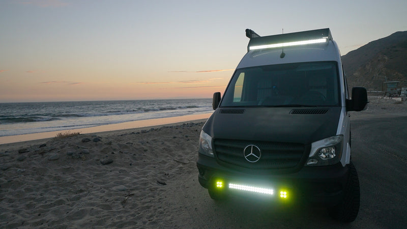 This Mercedes Sprinter RV rental shines bright on a sandy beach at sunset, perfect for coastal camping adventures. — photo 2