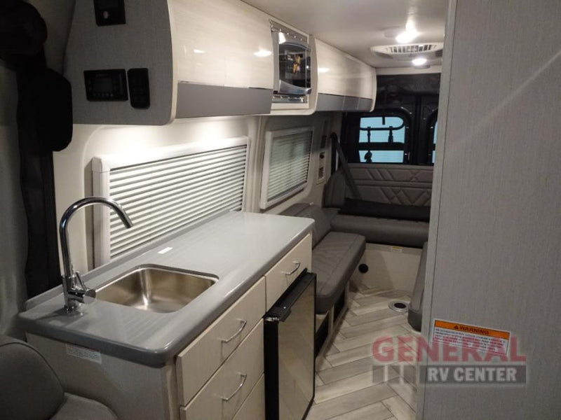  equipped for adventure.|This gray RV rental camper van features a rear bike rack and rooftop AC unit — photo 4