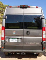Rear view of a gray Colorado rv rental camper van, displaying its license plate, mountain logo, and "DAVE & MATT VANS" text.