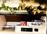 RV rental interior with books, games like Heads Up!, and a JVC stereo for your road trip entertainment.