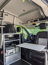 RV rental: Inside a custom camper van. Features a Dometic sink, portable fridge, and a versatile pull-out table.