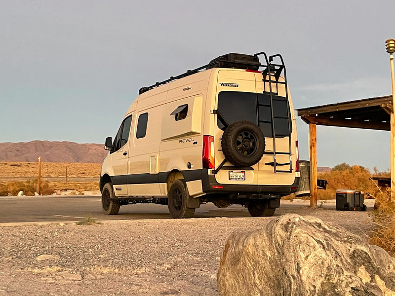  and tent. Friends gathered enjoying the wilderness.|Beige Winnebago Revel Sprinter RV rental parked at a rustic campsite with a picnic table — photo 10