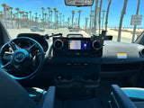 Inside a Mercedes-Benz RV rental, navigating a sunny coastal road with palm trees and the beach in view. Ready for adventure!