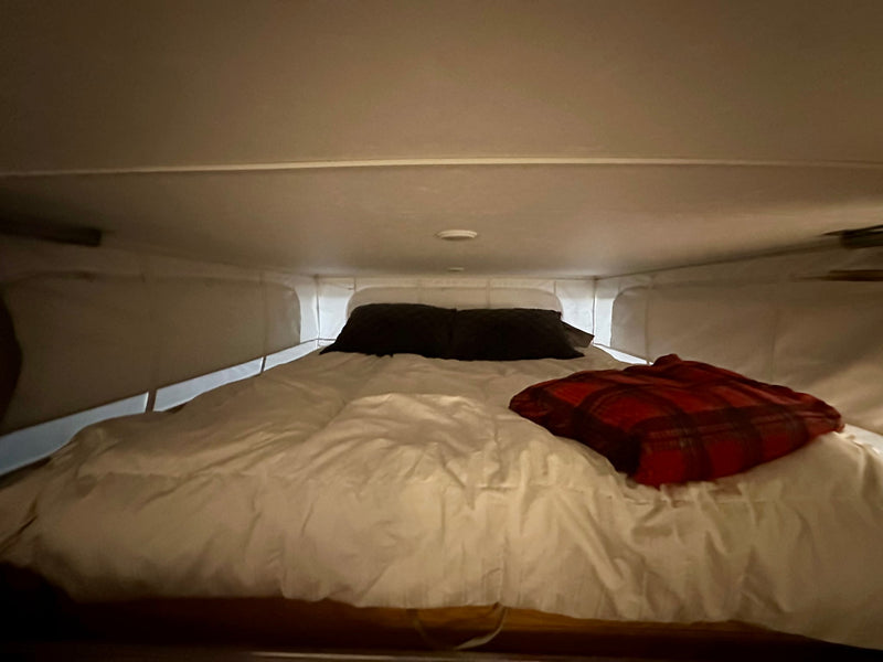  and dinette.|This RV rental's pop-up interior reveals an elevated bed — photo 13
