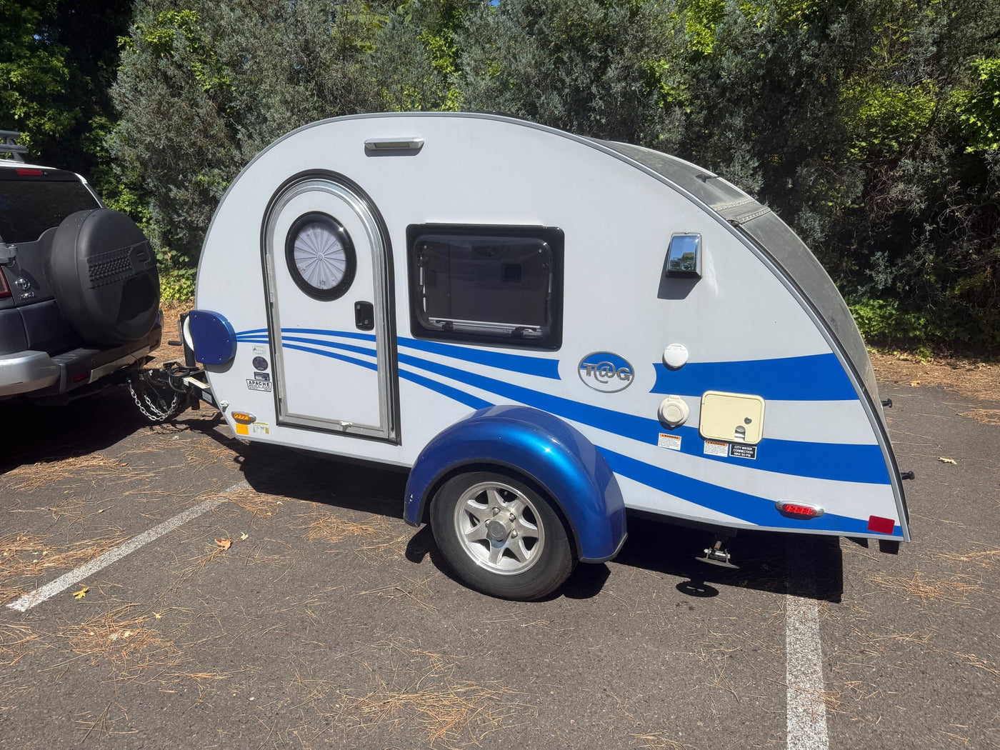  and a slide-out Norcold fridge.|RV rental outdoor kitchen featuring a dual-burner stove — photo 9