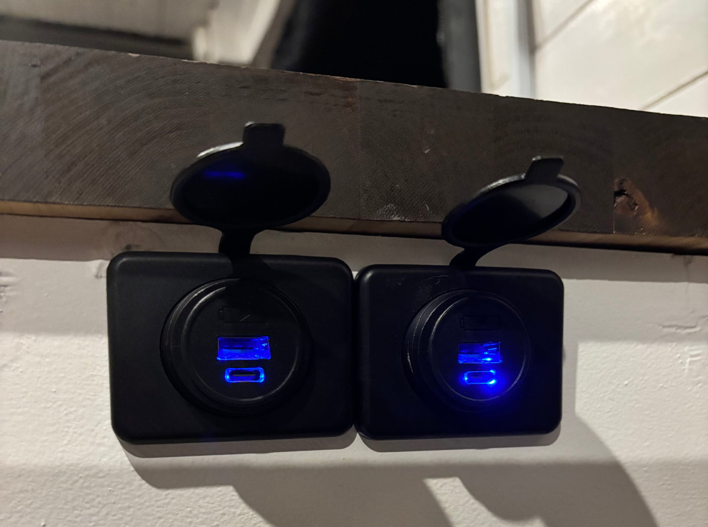 Two blue-lit USB charging ports in an RV rental, providing essential power for your devices on the go.