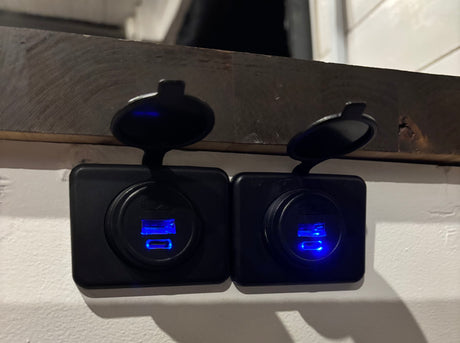 Two blue-lit USB charging ports in an RV rental, providing essential power for your devices on the go.