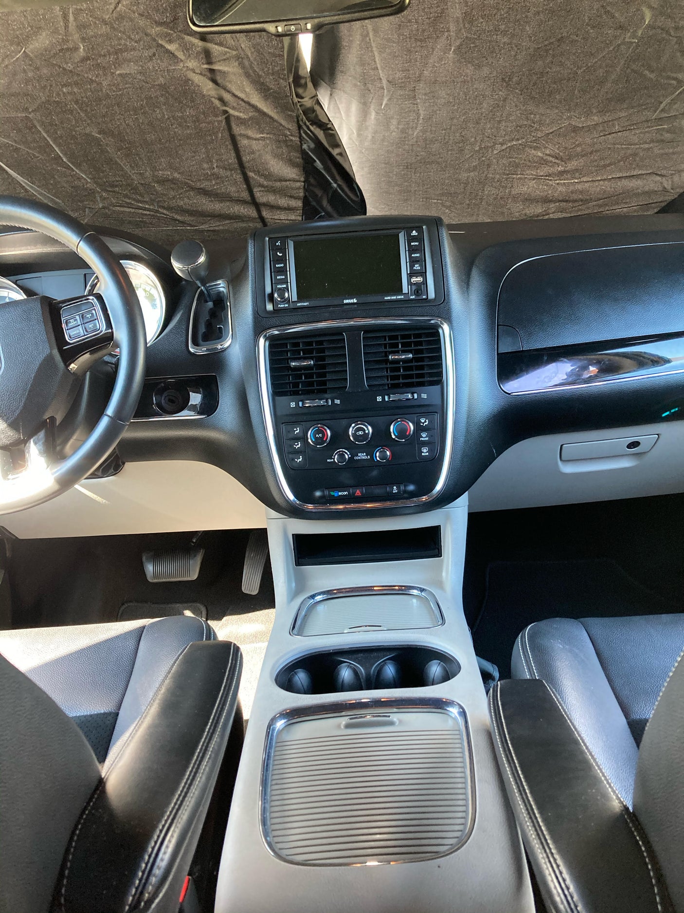 Detailed "RV rental" vehicle interior, showing the dashboard, steering wheel, infotainment display, and climate controls.