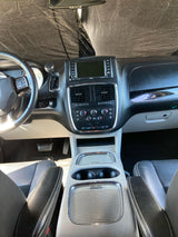 Detailed "RV rental" vehicle interior, showing the dashboard, steering wheel, infotainment display, and climate controls.