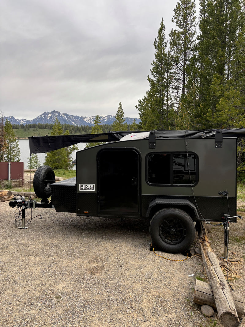 Hiker Trailer teardrop RV rental at a scenic mountain-lake campsite — photo 1